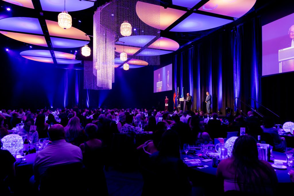 An awards night in which attendees sit a tables in small groups