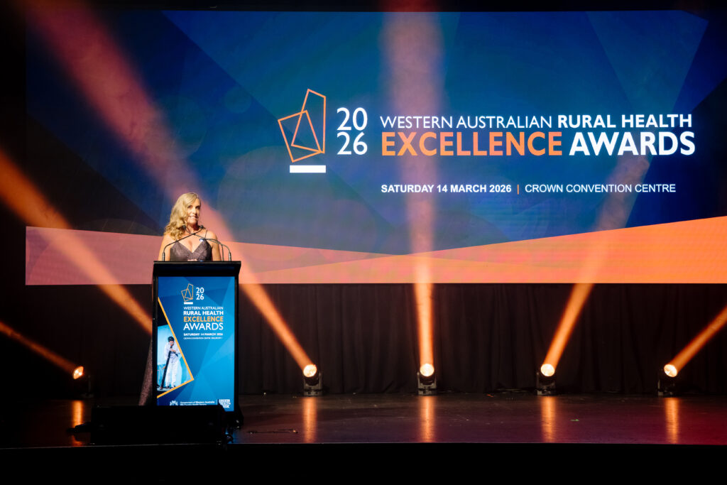 Woman on stage at Excellence Awards