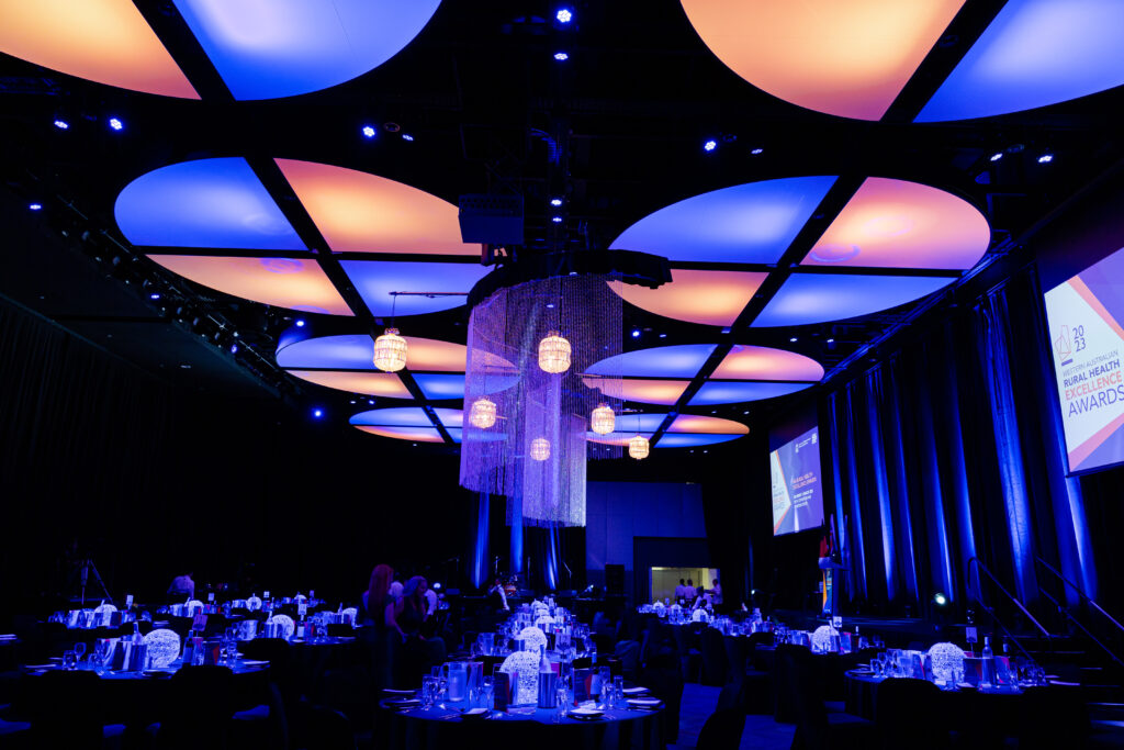 Awards night with the chandelier in focus and tables being set up