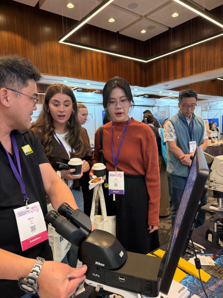 Exhibitors in exhibition hall showing delegates equiptment